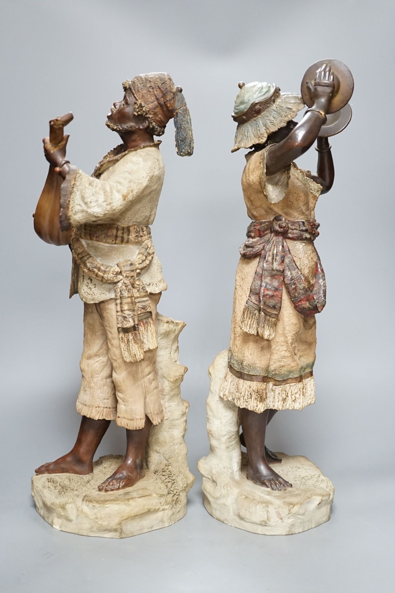 A pair of terracotta musician figures, incised numbers to base, 49cm